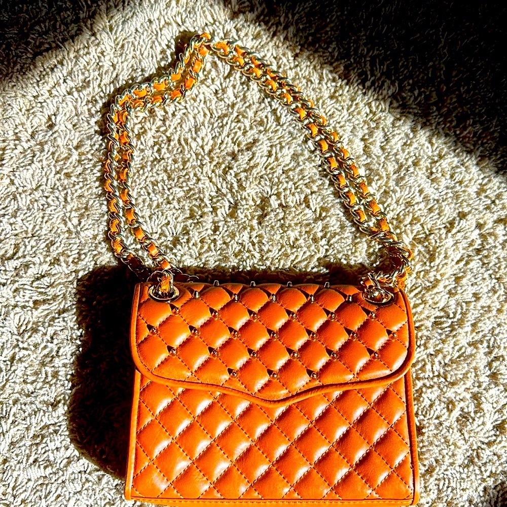 Rebecca Minkoff faux leather handbag with Gold grommet embellishments.